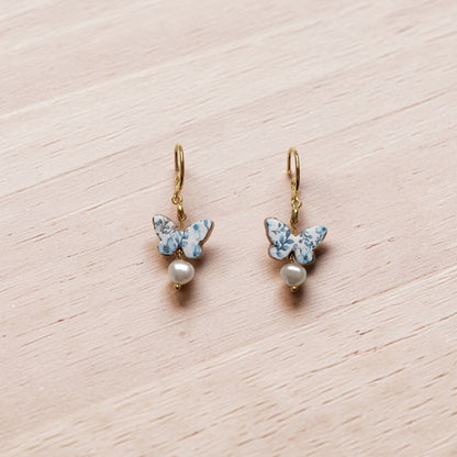 Enchanted Elegance blue chinoiserie butterfly dangles, coastal boho pearl earrings, patterned clay jewelry for summer vacations, butterfly gift for her.